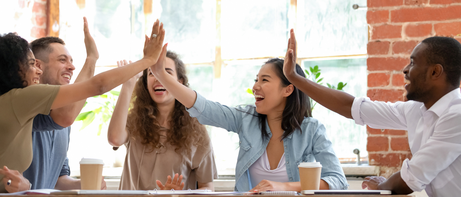 Excited employees or students feels happy giving high five